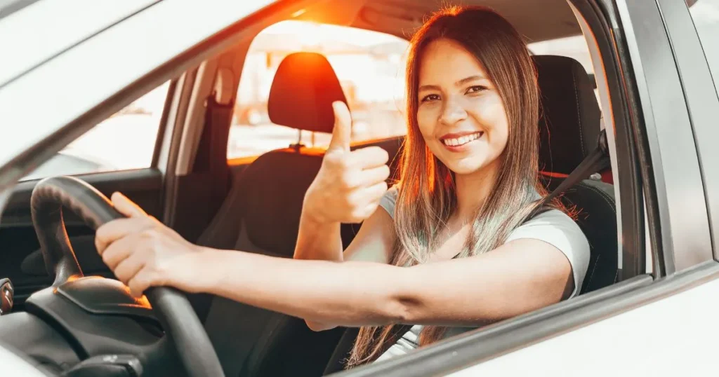 A girl with car showing thumb